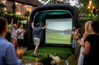 A guest celebrates a shot in the simulator at a garden party